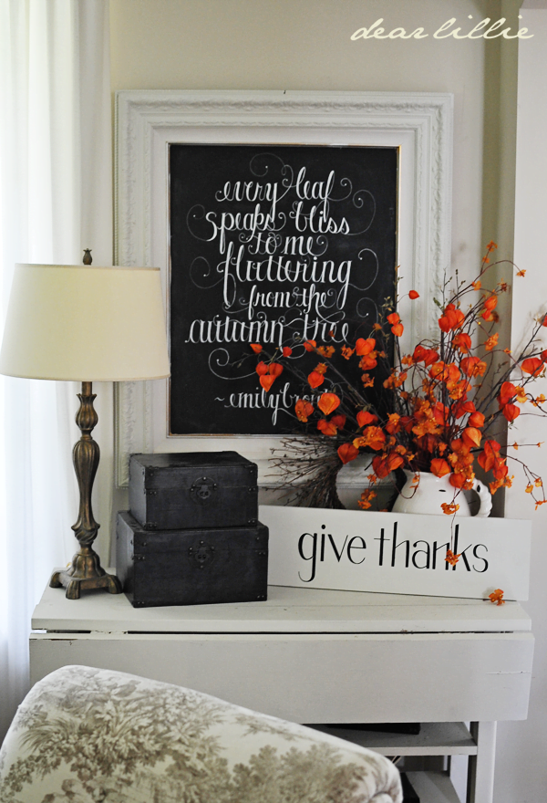 Black and White Mantel Decor with Studding Red Foliage Accent