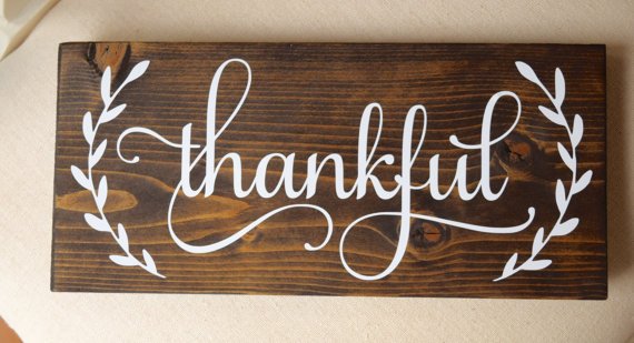 Wooden Sign with Handwritten "Thankful" in White Paint