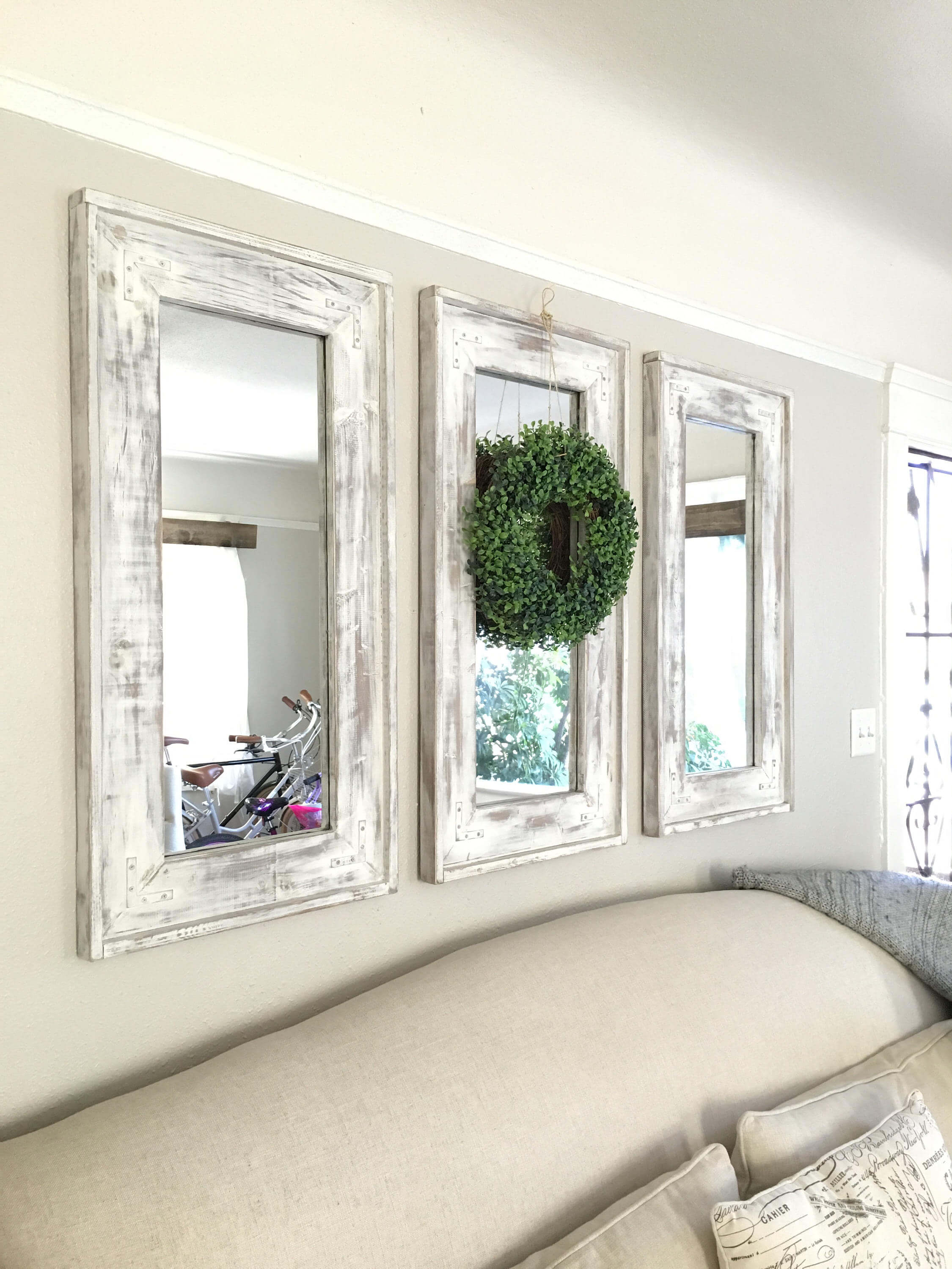 Retrofitted Wall Mirrors with Natural Wreath Accent