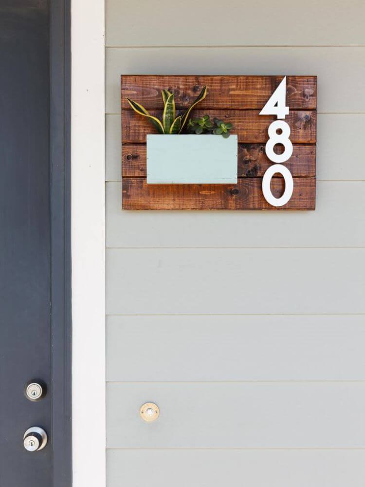 A Wooden Plaque with a Succulent Planter