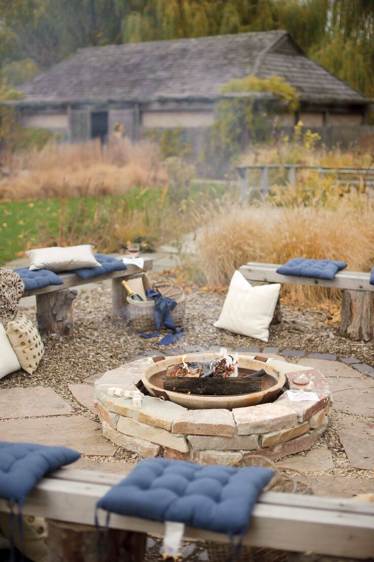 A Backyard Fire Hole With Comfortable Cushions