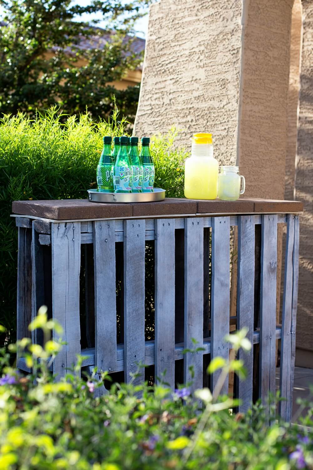 A Recycled Pallet Bar Near a Hedge