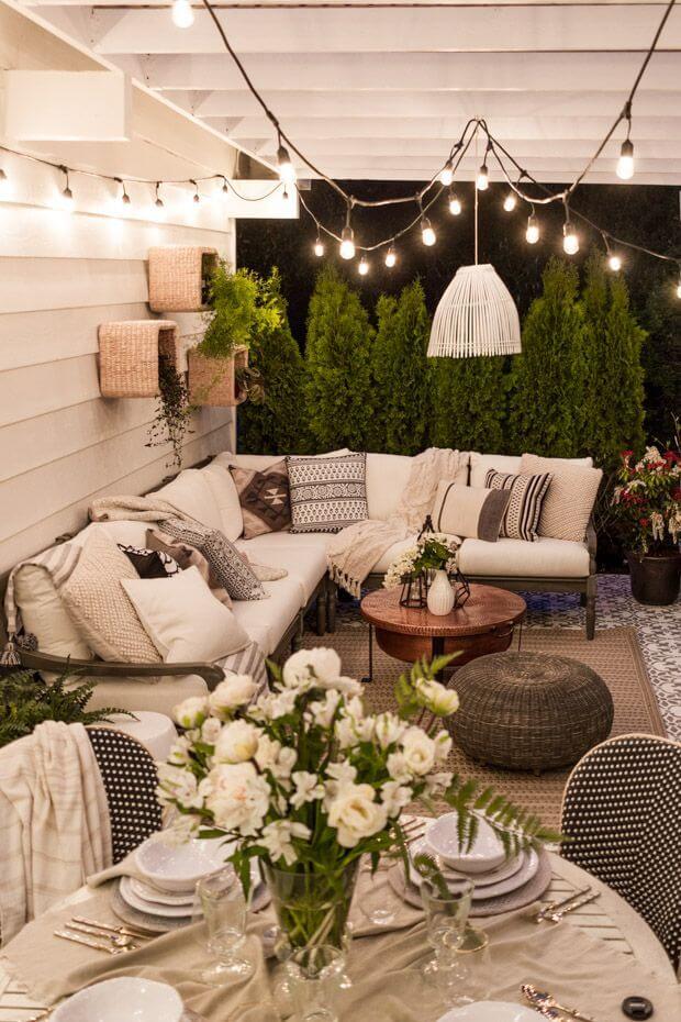 Clean White Walls, Fabric, and Bulbs Lighten this Outdoor Space