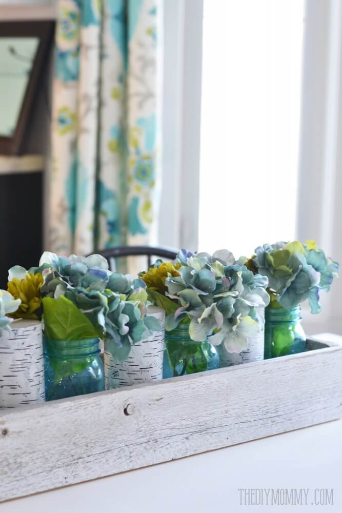 Blue Hydrangea Arrangement in Colored Bottles