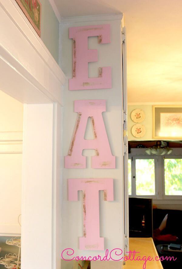 Antique Wooden Letters on a Pastel Wall