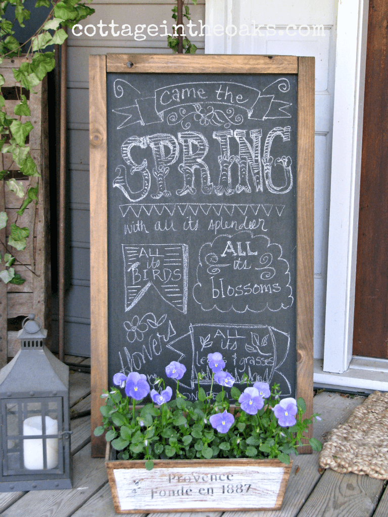 Chalkboard With Wooden Planter and Decorative Lantern