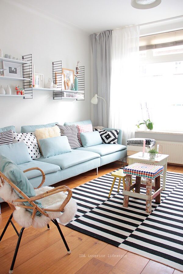 Sky Blue Sofa with Bold Striped Rug