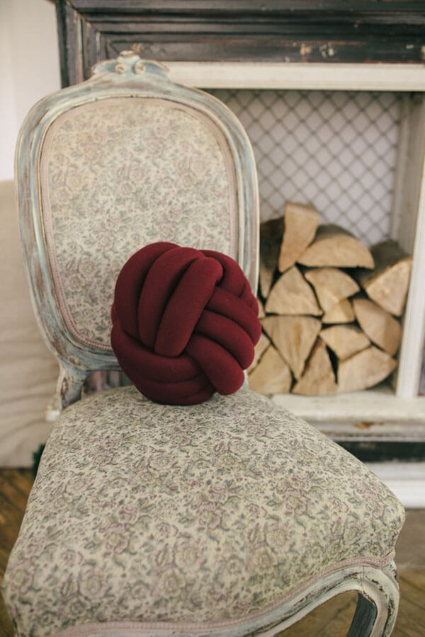 Burgundy Knot Pillow Adds a Decorative Touch