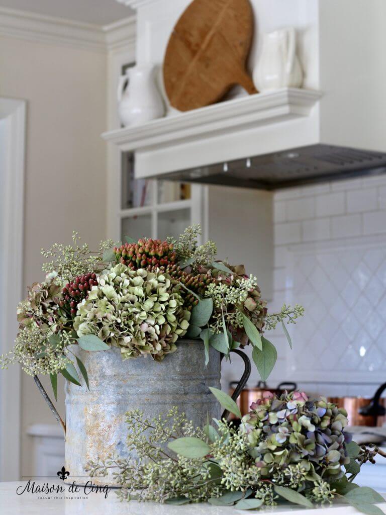 Clever Watering Can Flower Arrangement on Coffee Table for the Farmhouse Living Room