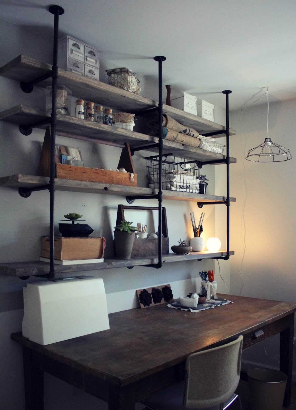 Rustic Ceiling-Mounted Wood and Pipe Craft Shelves