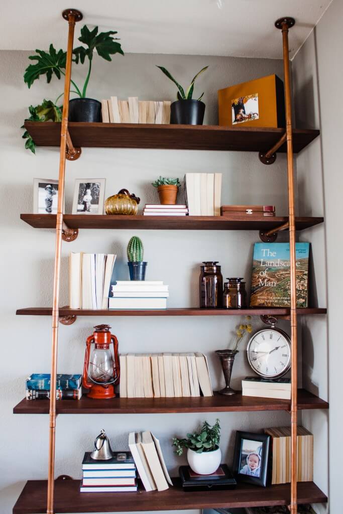 Bright, warm copper pipe and mahogany shelf