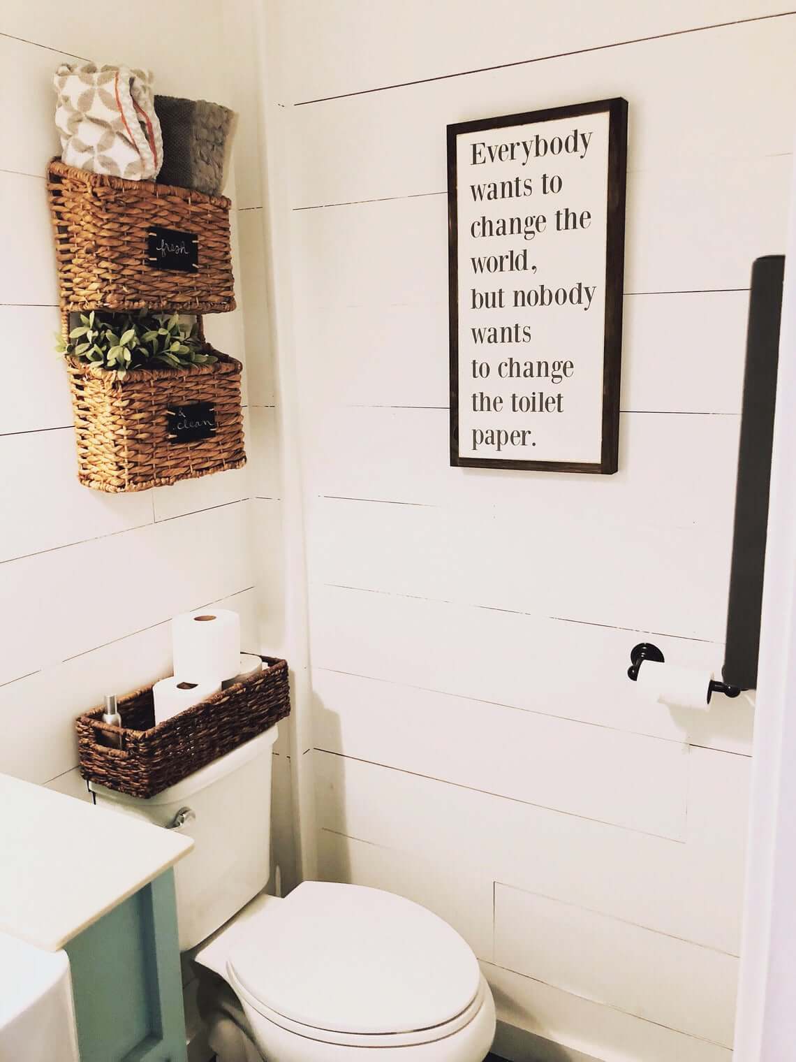 Storage Galore with Woven Baskets and Fun Bathroom Sign