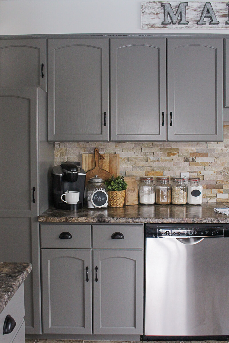 Dramatic Grey Cabinets Complement a Neutral Backsplash