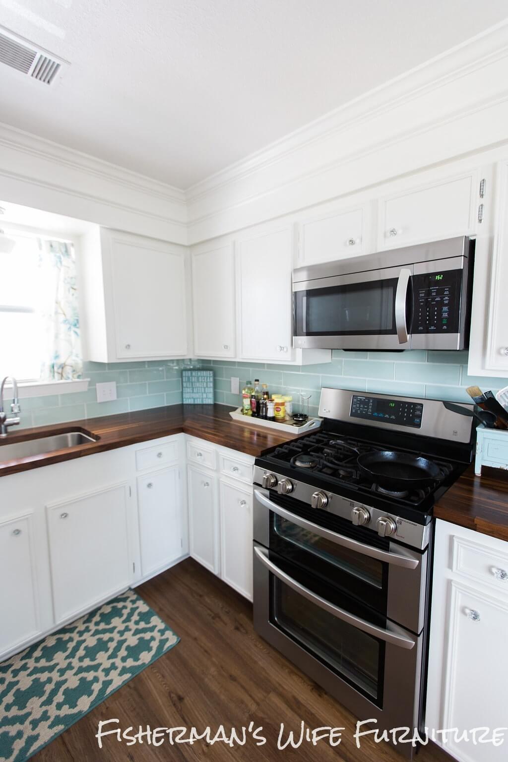 Blue and White Kitchen With Plank Flooring