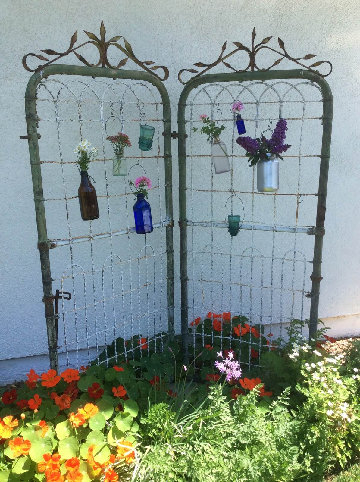 Whimsical Iron Gate with Flower Vases