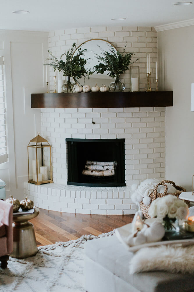 A Curved Fireplace Decorate in Brass and Nature