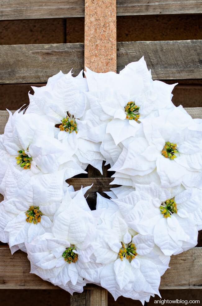 White Christmas Wreath Packed with Pristine Poinsettias