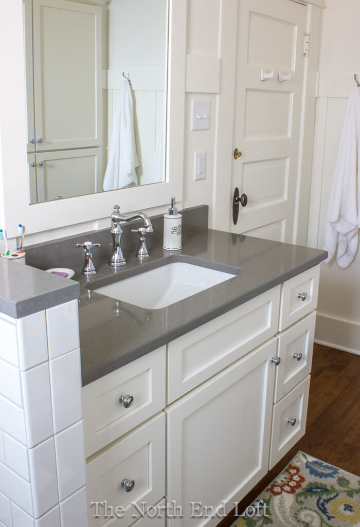 white bathroom cabinets with dark countertops